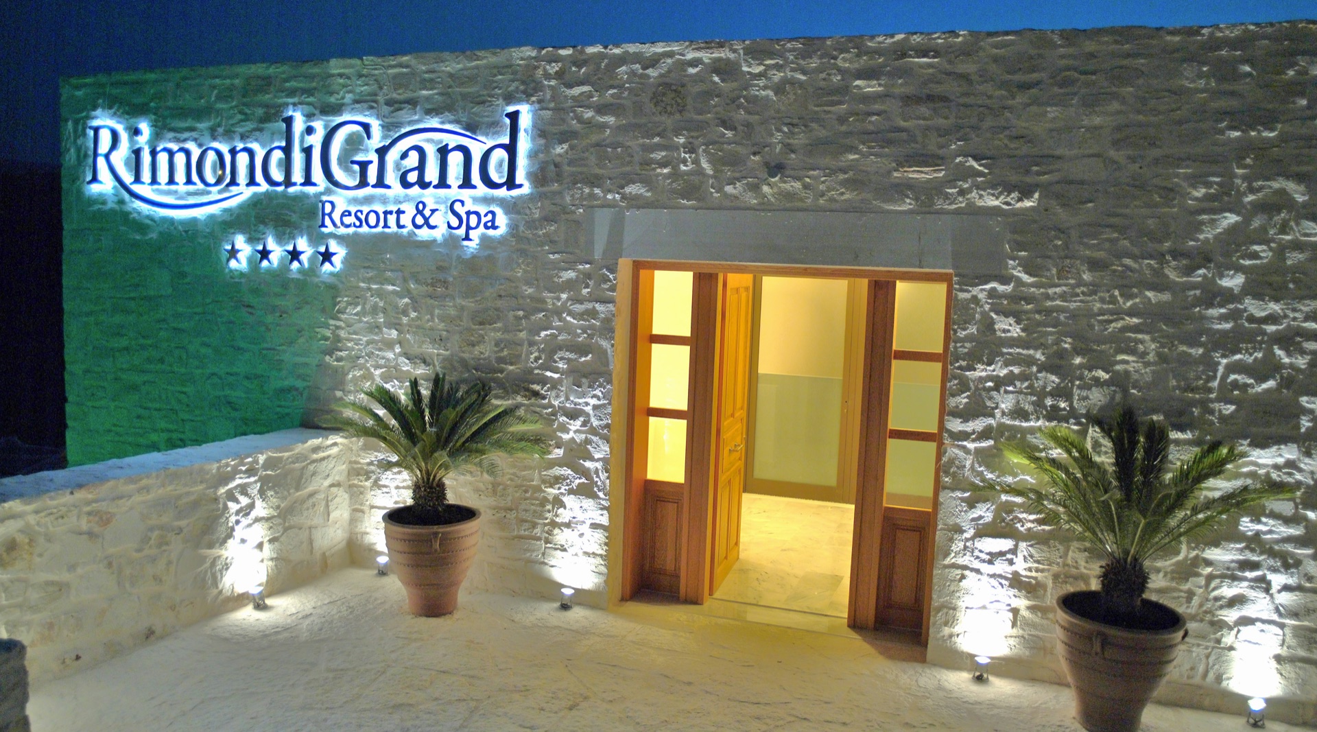 Rimondi Grand Resort & Spa exterior and pool at night